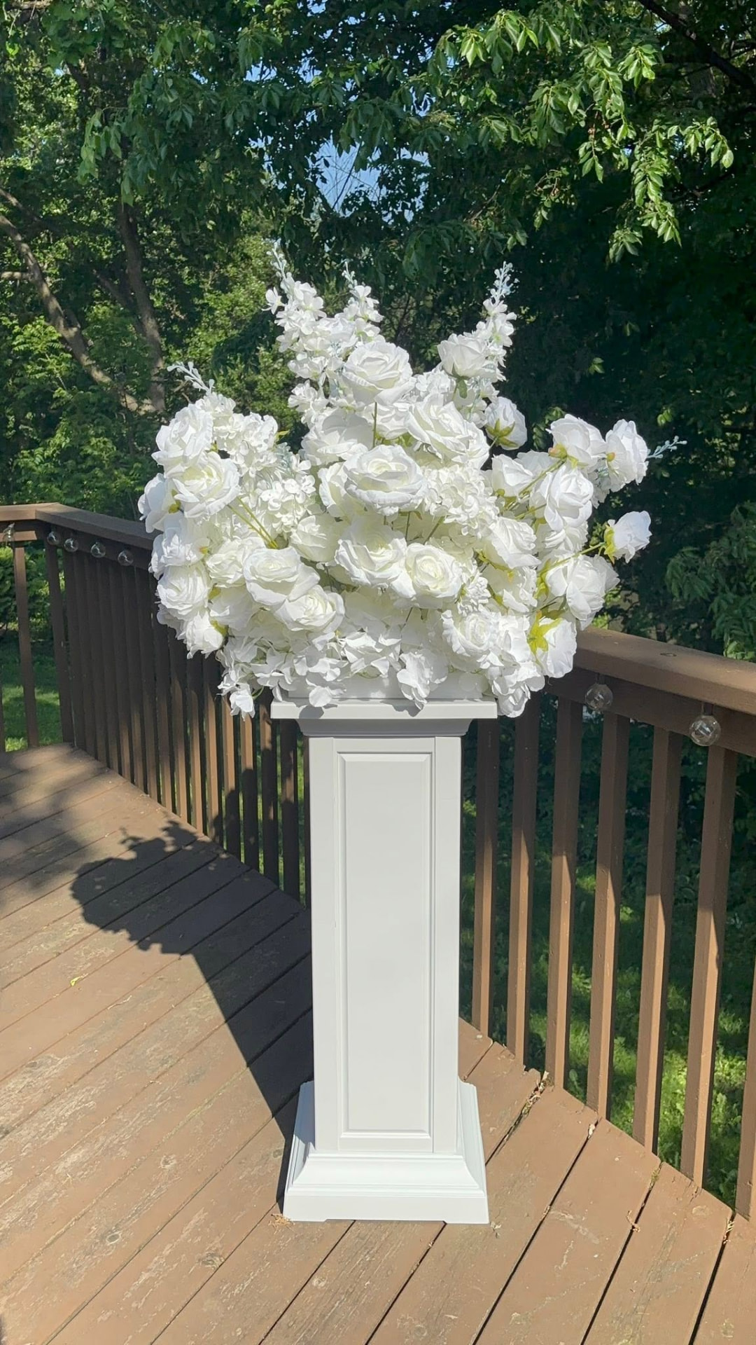 White hydrangea arrangement on a tall pedestal